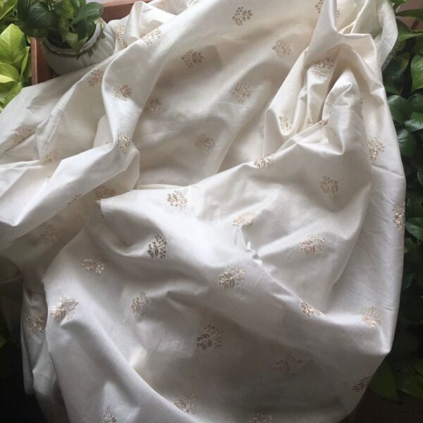 An ethereal Ivory Offwhite Running fabric in pure Silk Chandheri with exquisite Zari embroidery throughout. The fabric can be cut in meterage as per your requirement. The fabric with Zari embroidery is ideal to converted as saree , suit , yoke portions or frock & is hand crafted on pure silk Chandheri & is entirely dyeable to the shade of your choice