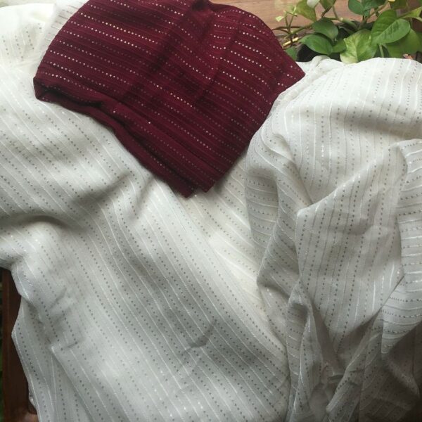 An ethereal Ivory Offwhite Running fabric in pure Viscose Georgette with exquisite embroidery throughout in vertical lines ! The fabric can be cut in meterage as per your requirement. The fabric with Zari embroidery is ideal to converted as saree , suit , yoke portions or frock & is hand crafted on pure viscose georgette & is entirely dyeable to the shade of your choice