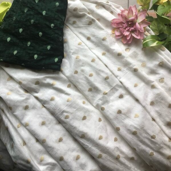 An ethereal Ivory Offwhite Running fabric in pure Uppada silk with exquisite Benarasi hand weaving throughout .