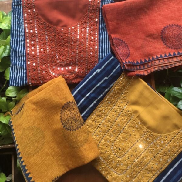 A stunning designer collection in pure indigo cotton top with intricate mirror work & hand embroidery detailing,cotton bottom & Kota Doria block printed duppata