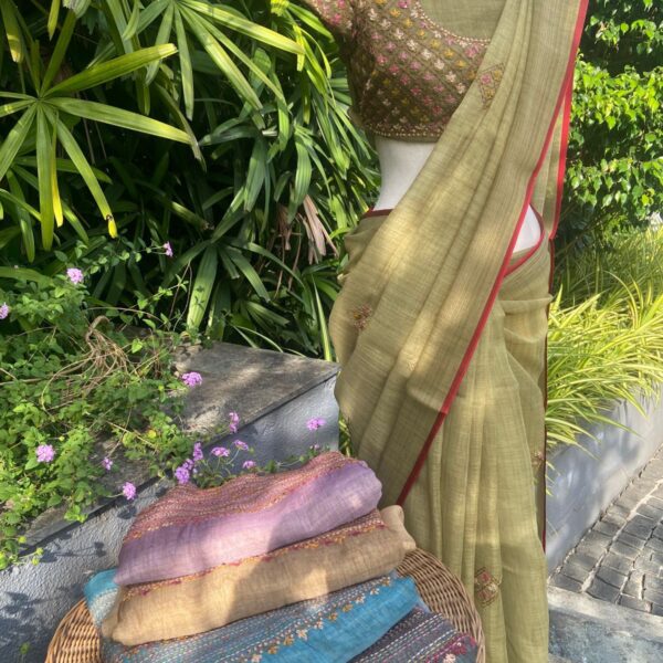 A stunningly gorgeous premium Chandheri silk saree with beautiful hand embroidery all along saree , blouse & pallav. The saree is delicately adorned with a thin red silk trimming which adds to the style quotient