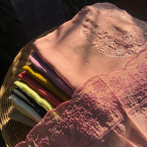 A beautiful collection of Pure silk organza top & Duppatta with exquisite hand embroidery detailing on yoke & embroidery & scallop detailing on Duppatta .santoon bottom