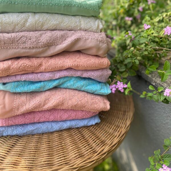 A beautiful collection of pure Silk Organza top & Duppatta with exquisite Chikankari hand embroidery throughout & pretty French lace detailing to add to the style quotient. Santoon bottom. Chikankari suits are a must have in ones wardrobe & is one style that never goes out of trend