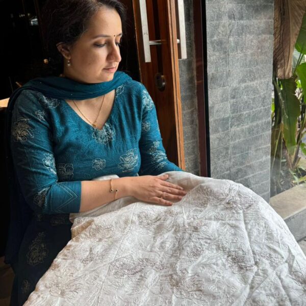 An ethereal Ivory Offwhite Running fabric in pure Uppada silk with intricate Zari & threads embroidery throughout. The fabric can be cut in meterage as per your requirement. The fabric with tiny embroidery is ideal to converted as saree , suit or frock and is hand crafted on pure Uppada & is entirely dyeable to the shade of your choice