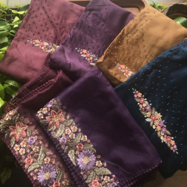 Are you looking out for Beautiful & Premium Silk Suits to add to your wardrobe ? These Silk Suits with exquisite hand embroidery detailing are the perfect choice! Pure Benarasi Chandheri Silk top with hand embroidery detailing at yoke , embroidery on sleeve borders , embroidered borders on santoon bottom & stunning Organza Duppatta with embroidery