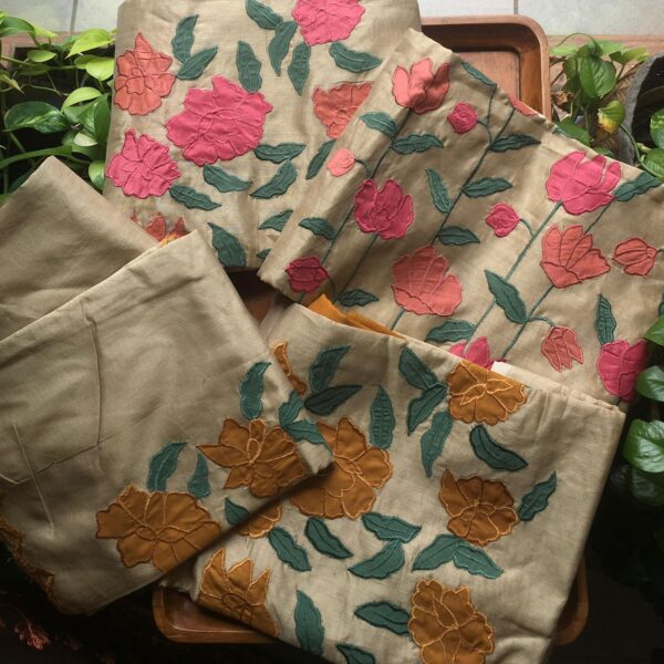 Are you looking out for Beautiful & Unique Designer wear suits in Silks to add to your wardrobe ? These Applique worked silk suits are the perfect choice!Pure Benarasi Chandherisilk top with appliqués , cotton bottom & silk scalloped Duppatta with appliqués